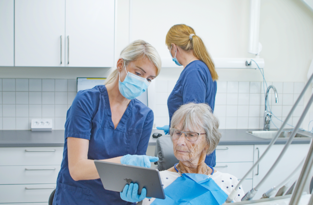 Dentist showing OsstellConnect to her patient